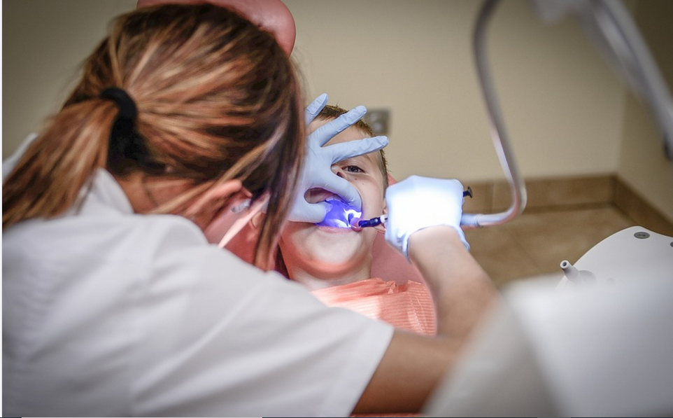 a dentist attending to a boy